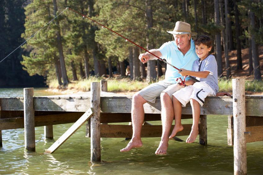 retired man with grandson fishing