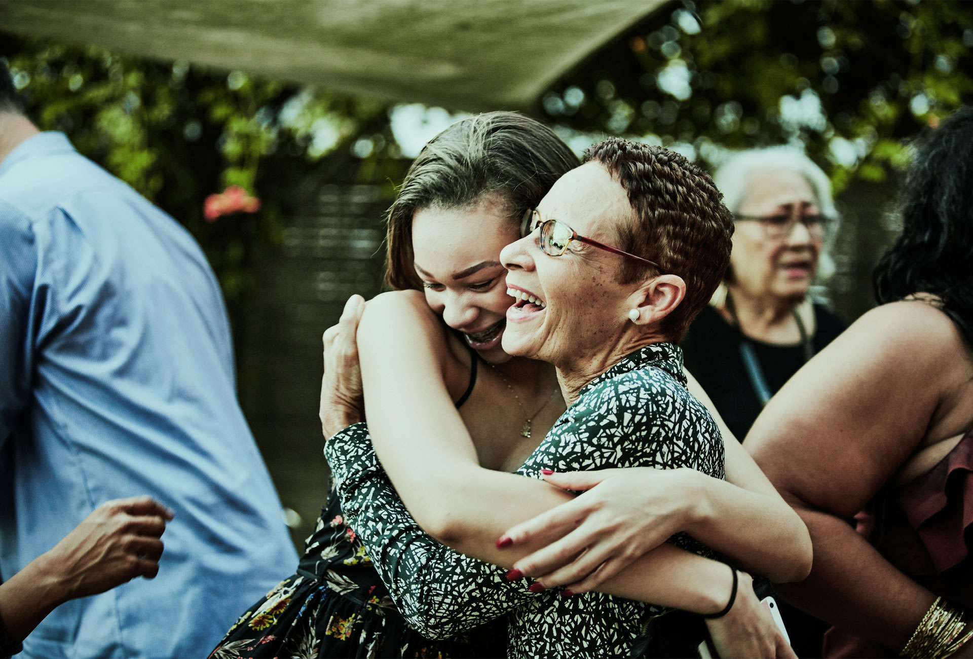 young woman and older woman hugging