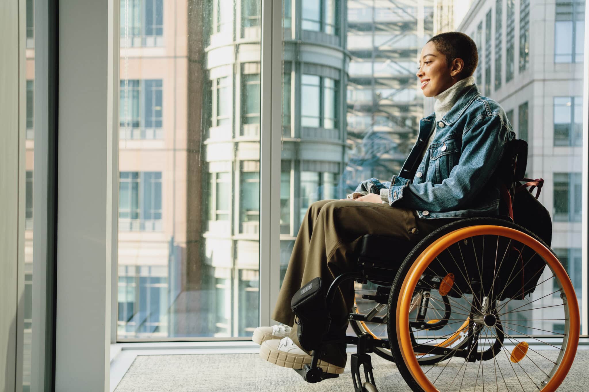woman in a wheelchair looking out the window
