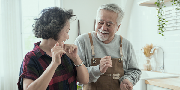older woman and man in the kitchen smiling