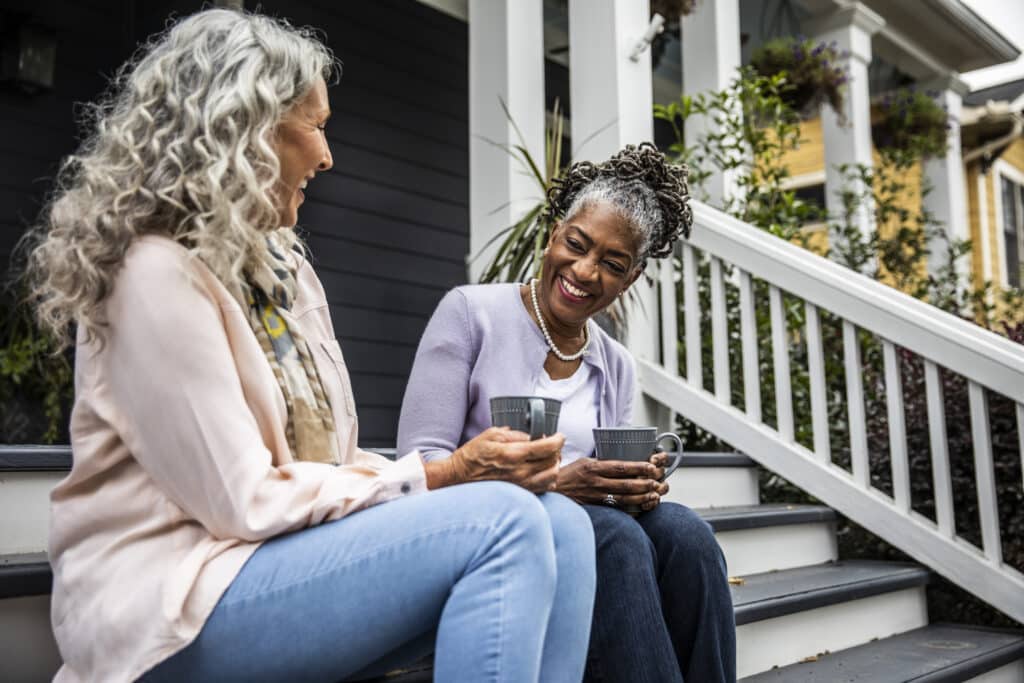 Two women sitting on front porch