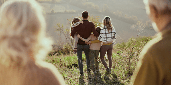 older-couple-looking-at-younger-family-from-a-distance